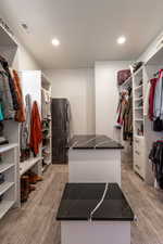 Master suite walk in closet featuring light wood-style flooring and washer and dryer