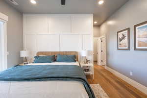 Main floor master suite featuring light wood-type flooring, baseboards, recessed lighting