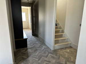 Hall featuring stairs to the upper level and floor