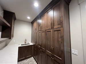 Bar area with a sink and recessed lighting