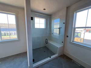 Master bathroom featuring tile patterned floors, separate tub and shower