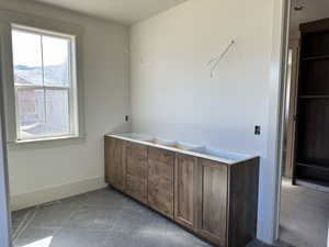 Master bathroom with tile patterned floors and walk-in closet