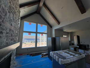 Great room with high vaulted ceiling and exposed beams