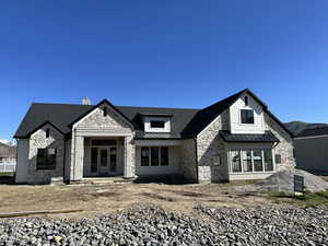 View of front of home with stone siding and shelter entry