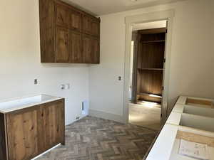Clothes washing area with cabinet space, hookup for an electric or gas dryer