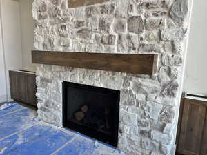Stone fireplace with cabinetry on the sides