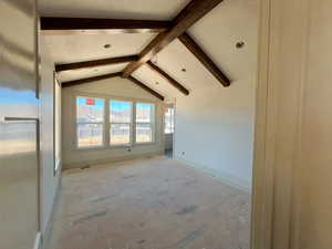 Master bedroom with vaulted ceiling and beams