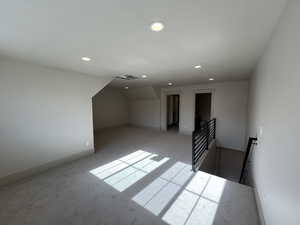 Bonus room featuring recessed lighting, light colored carpet, and baseboards