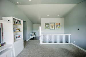 Additional living space with carpet, lofted ceiling, and baseboards