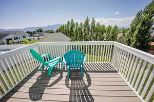 Wooden deck featuring a residential view and a mountain view