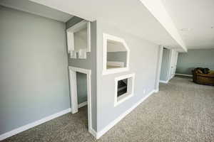 Interior space with baseboards and carpet floors