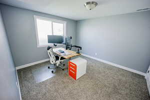 Home office featuring baseboards and visible vents