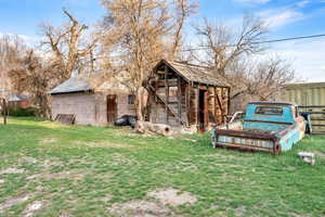 View of poultry coop with a yard and fence