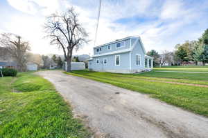 View of side of property with a yard