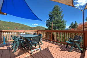 Deck featuring outdoor dining space and a mountain view