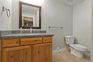 Bathroom with tile-patterned floors, vanity, and tub and shower combo