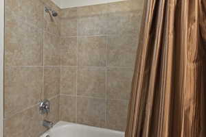 Interior details featuring shower / bath combination with curtain