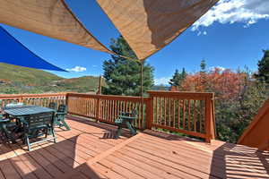 Deck featuring outdoor dining space and a beautiful mountain view