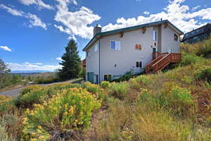View of house featuring a deck, and a stairway