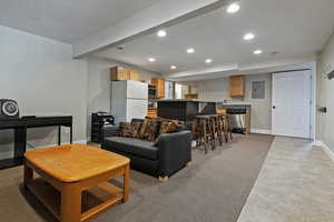 Living area with separate entrance, recessed lighting, and baseboards