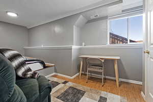 Bedroom featuring crown molding, wood finished floors