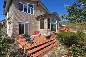 Back of property with a deck