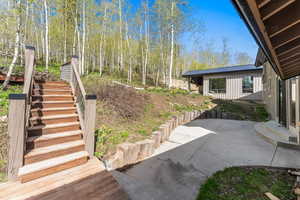View of yard featuring a patio and stairs