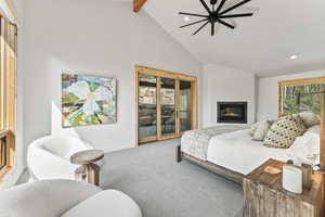 Bedroom with recessed lighting, carpet, access to exterior, beamed ceiling, and a glass covered fireplace