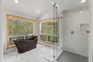 Bathroom featuring recessed lighting, a shower stall, and a healthy amount of sunlight
