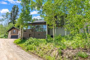 View of front facade with driveway and an outbuilding
