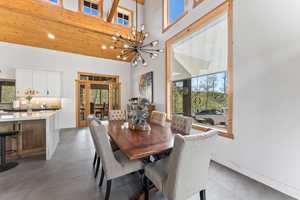 Dining space with recessed lighting, a high ceiling, and an inviting chandelier