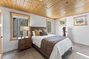 Bedroom featuring recessed lighting, baseboards, tile patterned floors, and wooden ceiling