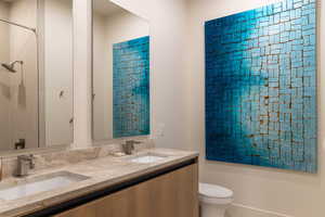 Full bath featuring  tub, double vanity, and toilet