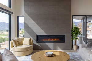 Living room featuring wood finished floors, a fireplace, and a mountain view