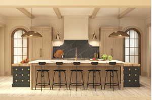 Kitchen with arched walkways, decorative backsplash, a kitchen breakfast bar, light countertops, and beam ceiling