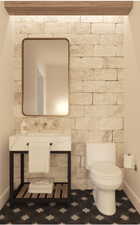 Half bath with baseboards and vanity