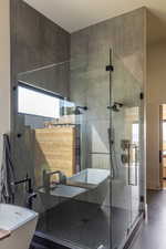 Primary bathroom featuring a freestanding tub, a sink, a wealth of natural light, and dual shower