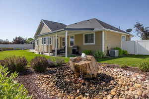 Rear view of property featuring a fenced backyard, a patio, a gate, and roof with shingles