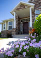 Doorway to property featuring a porch