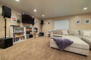 Living area with recessed lighting and carpet floors