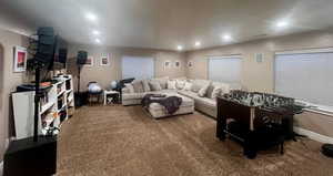 Carpeted living area featuring recessed lighting, visible vents, and baseboards