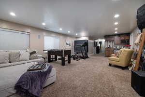 Living area featuring recessed lighting, light colored carpet, and arched walkways