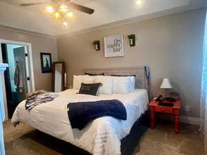Carpeted bedroom featuring baseboards and a ceiling fan