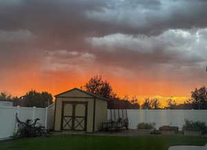 View of shed with a fenced backyard