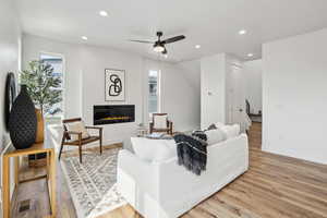 Living area featuring recessed lighting, light wood finished floors, and ceiling fan