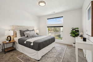 Bedroom with visible vents, carpet flooring, and access to outside