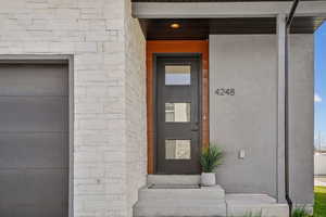 Entrance to property with stucco siding