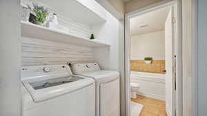 Laundry area featuring shelving w/ visible vents, laundry area, and light tile patterned floors