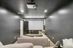 Cinema room with carpet, baseboards, and recessed lighting