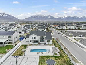 View of pool with a wall unit AC, a fenced backyard, a mountain view, a fenced in pool, and a residential view